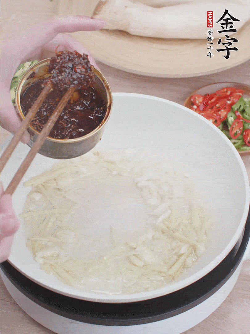 起鍋熱油，姜蒜、金字火腿干貝醬煸香。